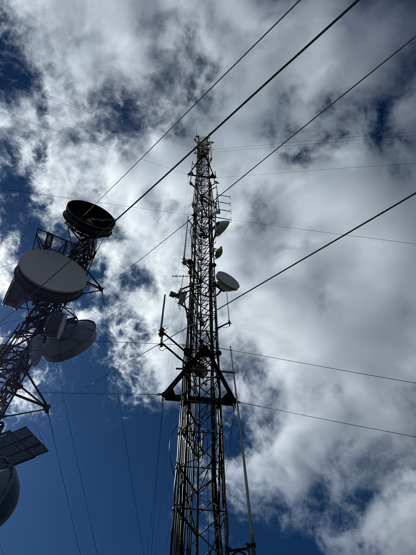 Looking up a communications tower equipped with microwave dishes