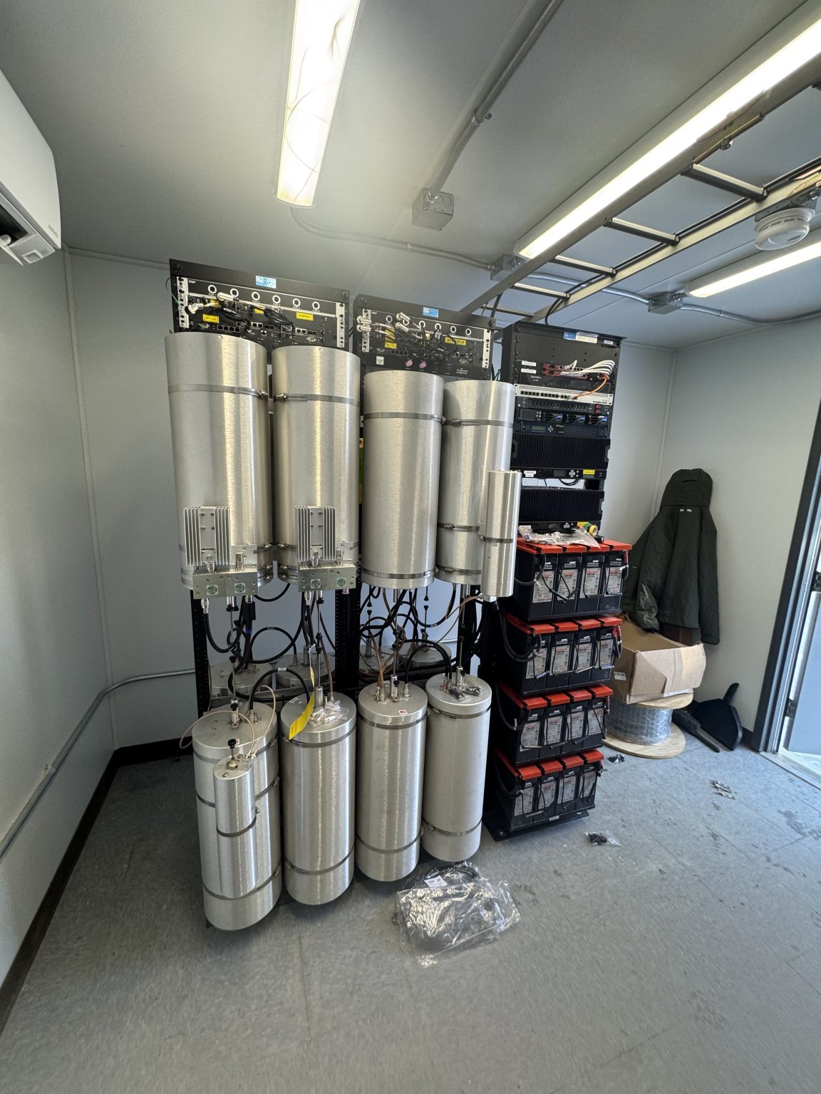 RF filter cavities and radio equipment racks inside a communications shelter